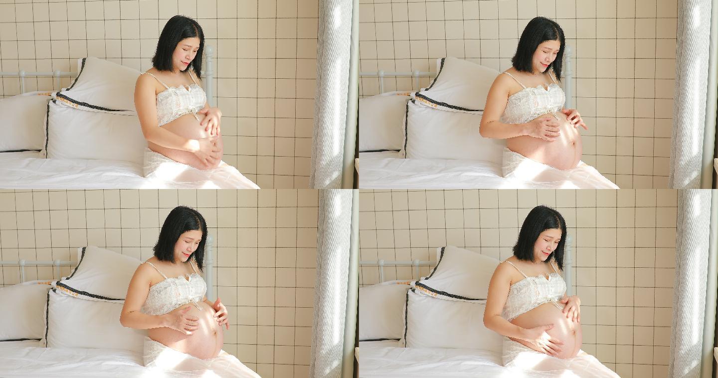 怀孕的准妈妈在抚摸自己的肚子4k最新