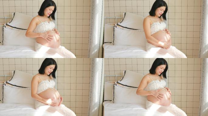 怀孕的准妈妈在抚摸自己的肚子4k最新