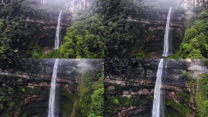 自然壮观峡谷中飘落而下的瀑布航拍