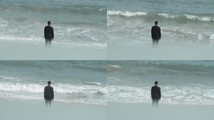 商务男奋斗拼搏海边思考面对挑战海浪背影