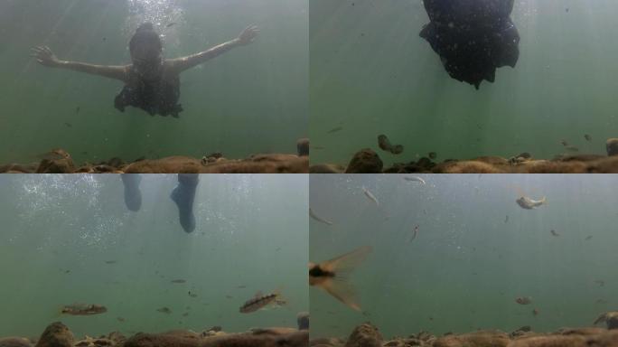 水下拍摄人从上面游过鱼在下面跟随