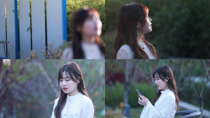 美女室外踏青看手机开心