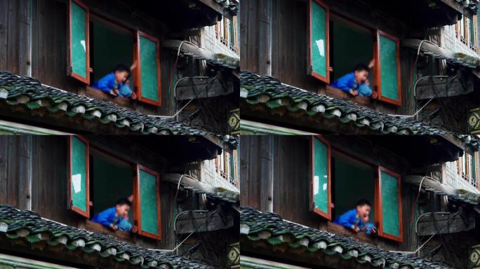 中式建筑窗户小孩在窗户呐喊瓦房木屋老房子