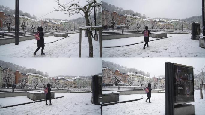 路人在欧洲的小镇雪中行走走路升格