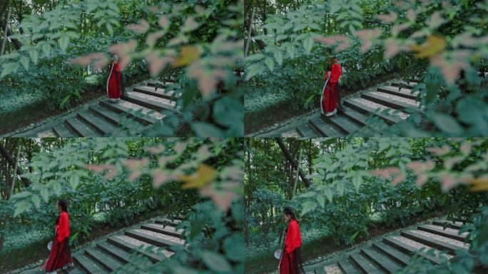 红裙汉服女子行走在林荫小径