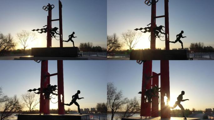 铁人三项赛雕塑清晨日出闪光芒