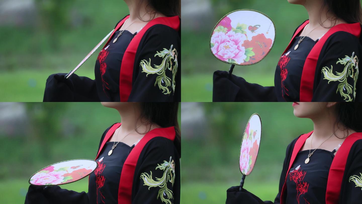 轻摇扇子的汉服古装女子