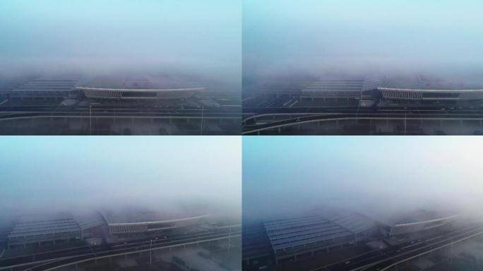 航拍晨雾中的襄阳东站高铁站火车站