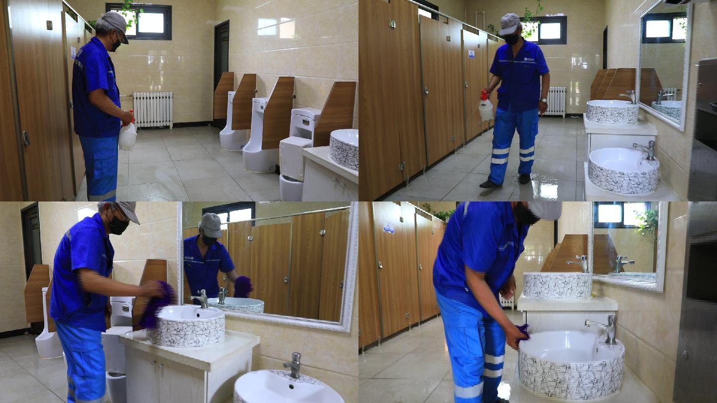 清洁工环卫工人给公共厕所消毒擦拭洗手池