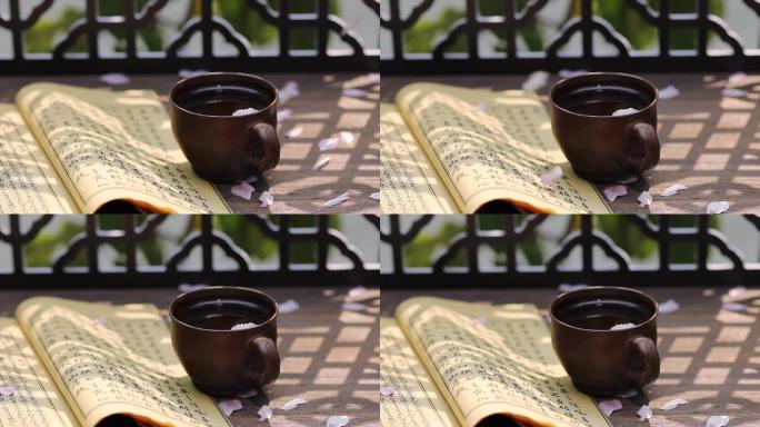 泛黄的书籍茶杯被风吹走的花瓣