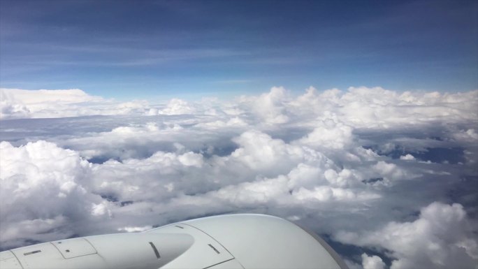 飞机航班舷窗外蓝天白云飘过