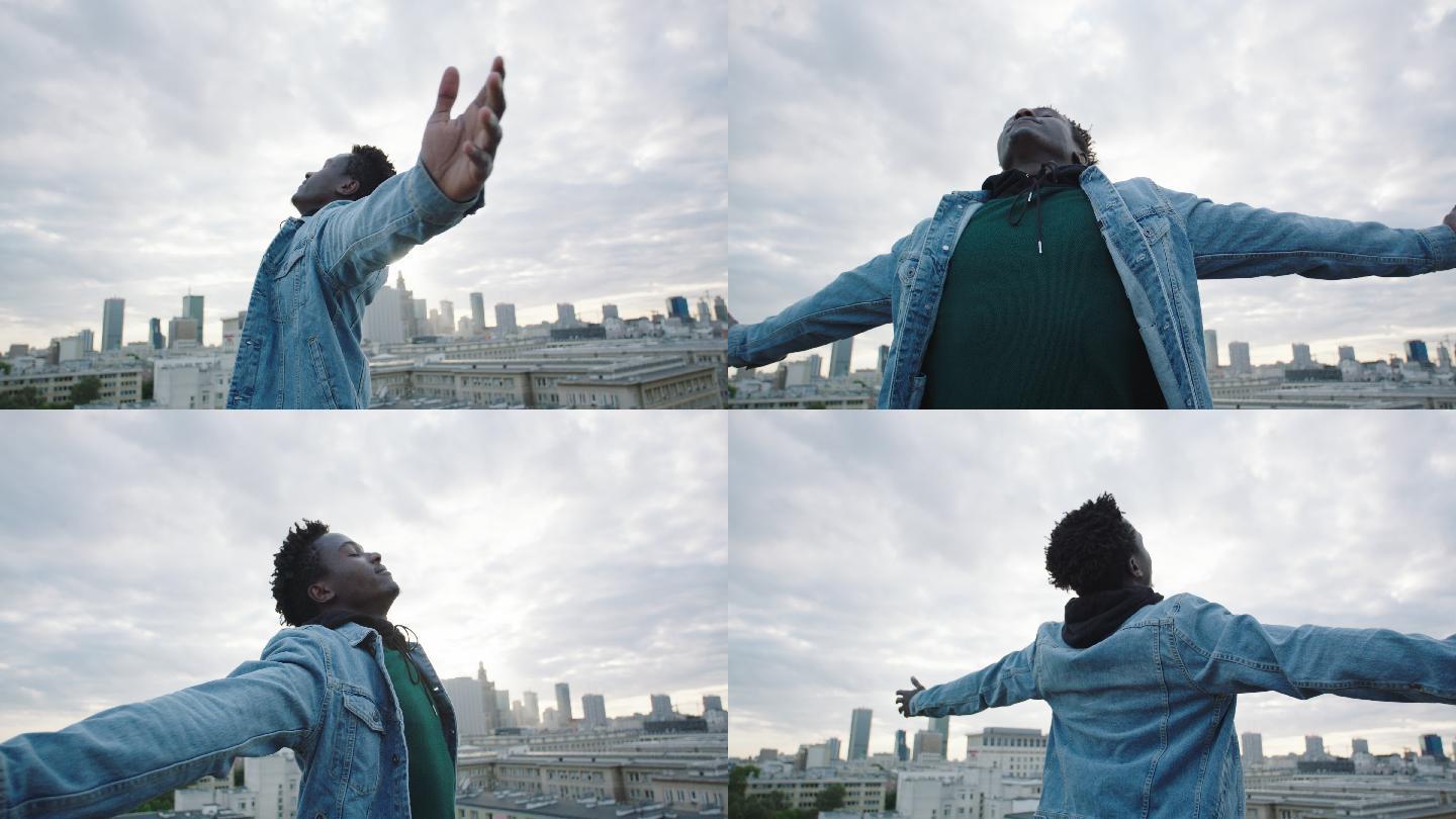 年轻人张开双臂在屋顶上转动._3840x2160_高清视频素材下载(编号:5683