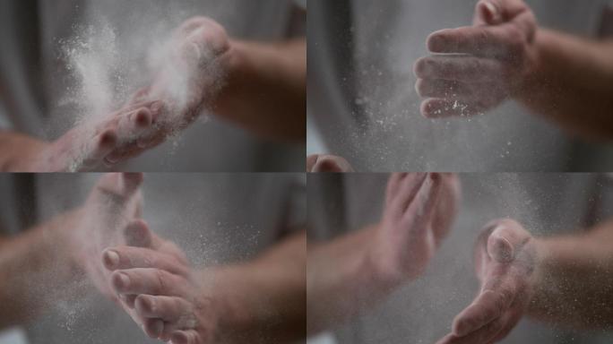 男人从面粉上拂去双手。烘烤。超慢动作