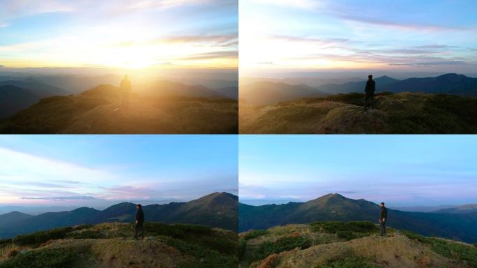 站在山顶上的人有一个美丽的日出