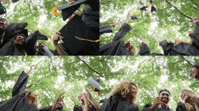 兴奋的大学毕业生外国大学生丢学士帽仰拍角