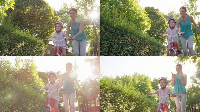 妈妈帮助她的女儿练习骑自行车