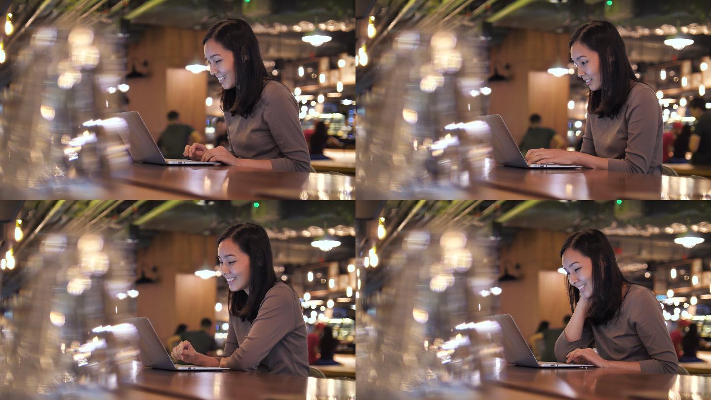晚上在咖啡馆用笔记本电脑的女人
