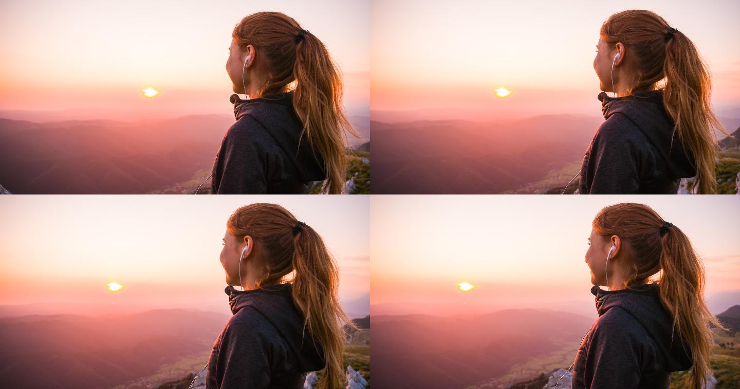 山顶上看日出的女人