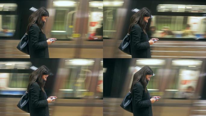 在地铁站使用智能手机的年轻女子。