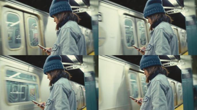 低头看手机的女人美国地铁公共出行交通运输