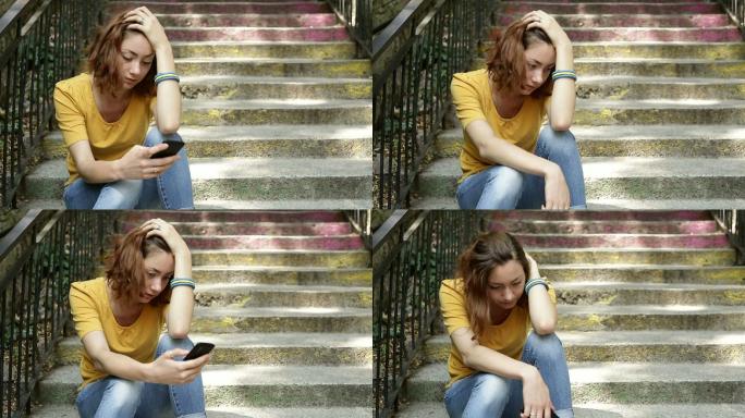 一个坐在阶梯上看短信的女人