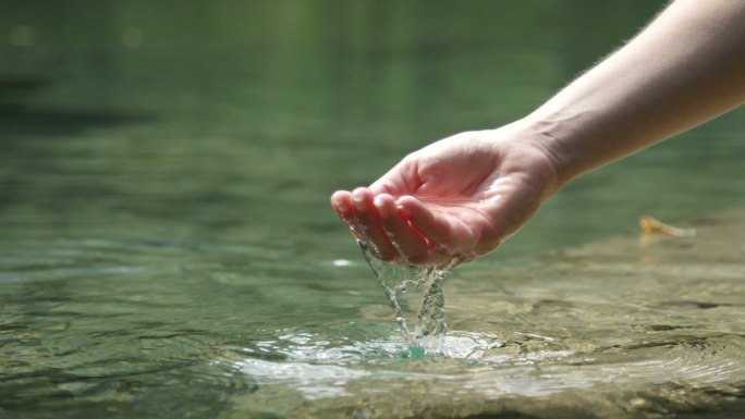 在美丽的山湖里用手玩清水