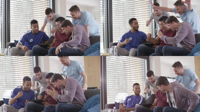 五个男人在数字平板电脑上看游戏