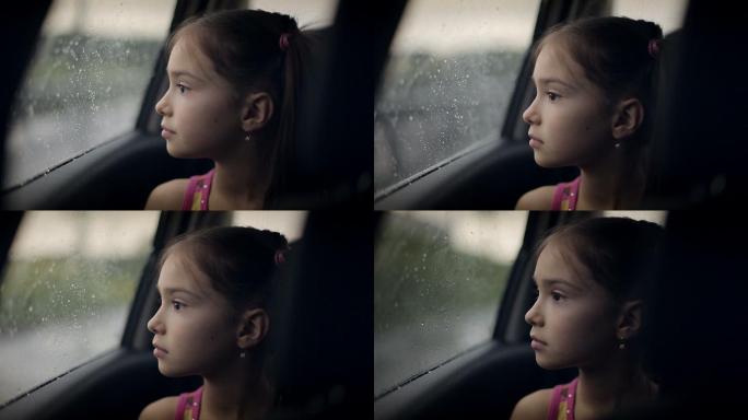 从车窗向外看的小女孩