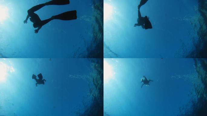 潜水员游回水面潜泳深潜水中拍摄自由潜