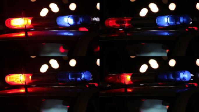 夜间市区警灯闪烁公安警车出警政府人民警察