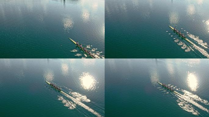 四名运动员在阳光下划过湖面