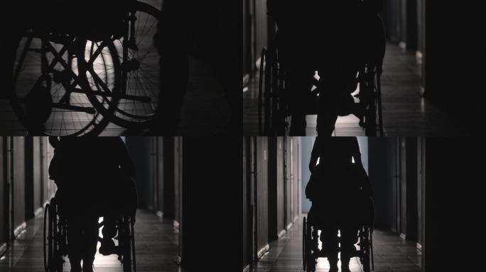 走廊上推着轮椅的女人剪影