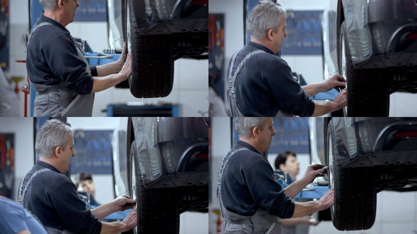 机械师在汽车修理厂更换轮胎