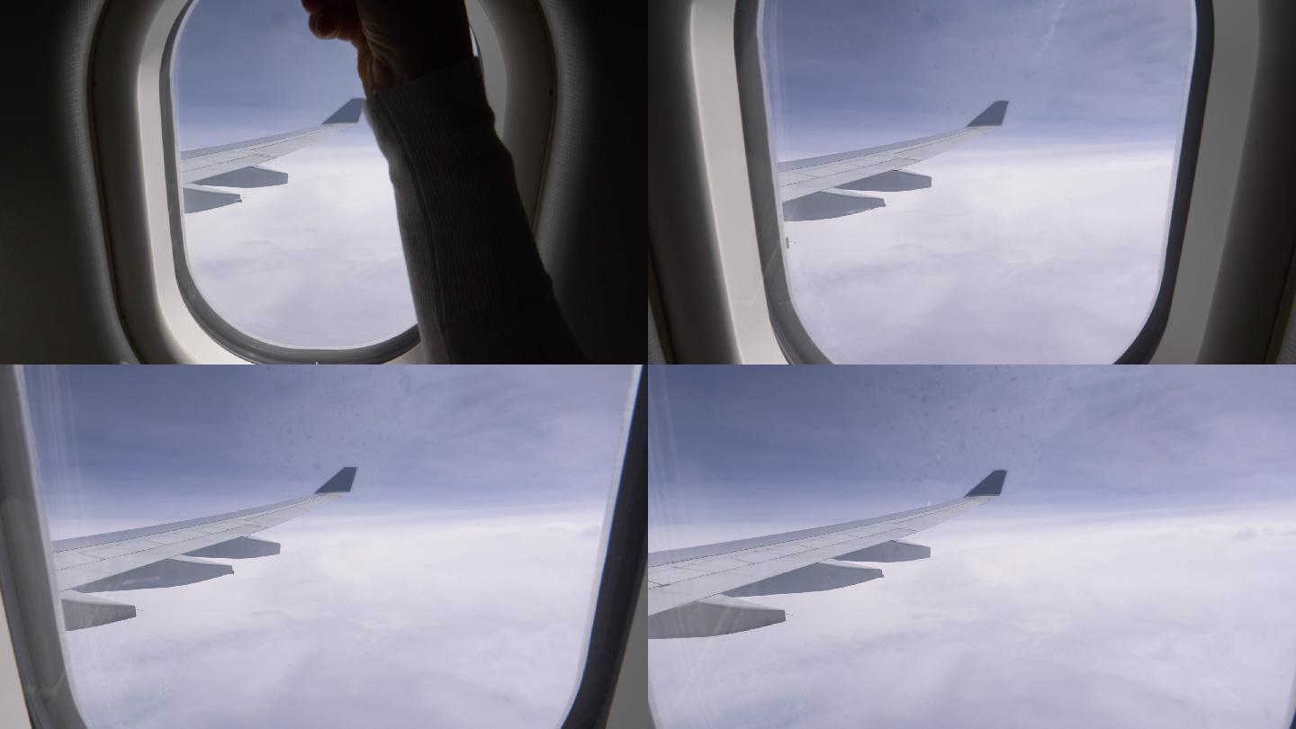 拉起飞机的窗帘打开窗空中云层