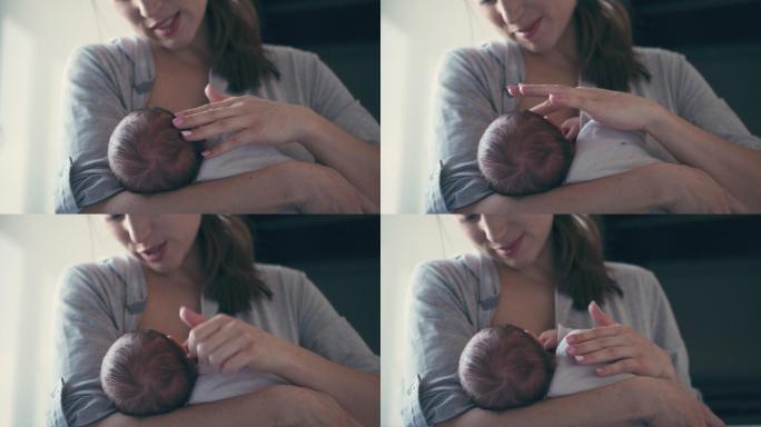 妈妈给她的小女婴喂奶