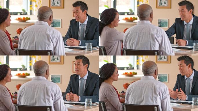 银行家在家中与一对老年夫妇沟通