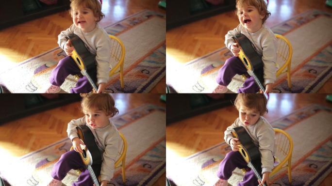 可爱的小女孩弹玩具吉他唱歌