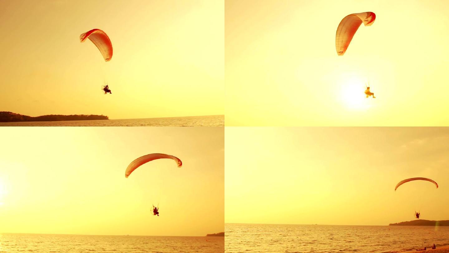 热带海滩上日落时滑翔伞的剪影