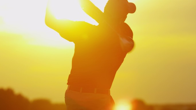 日落时在球道上开球的男高尔夫球手