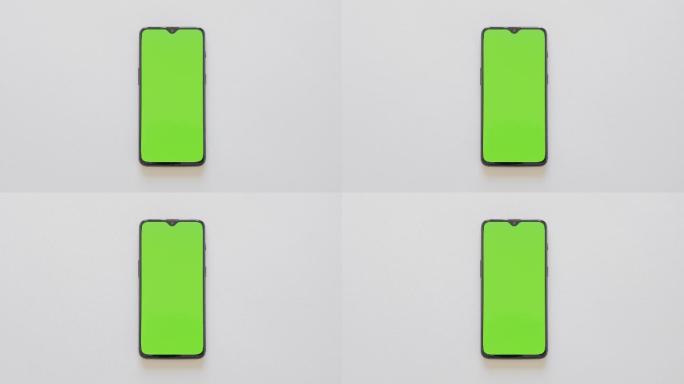绿色屏幕-现代智能手机位于白色背景上