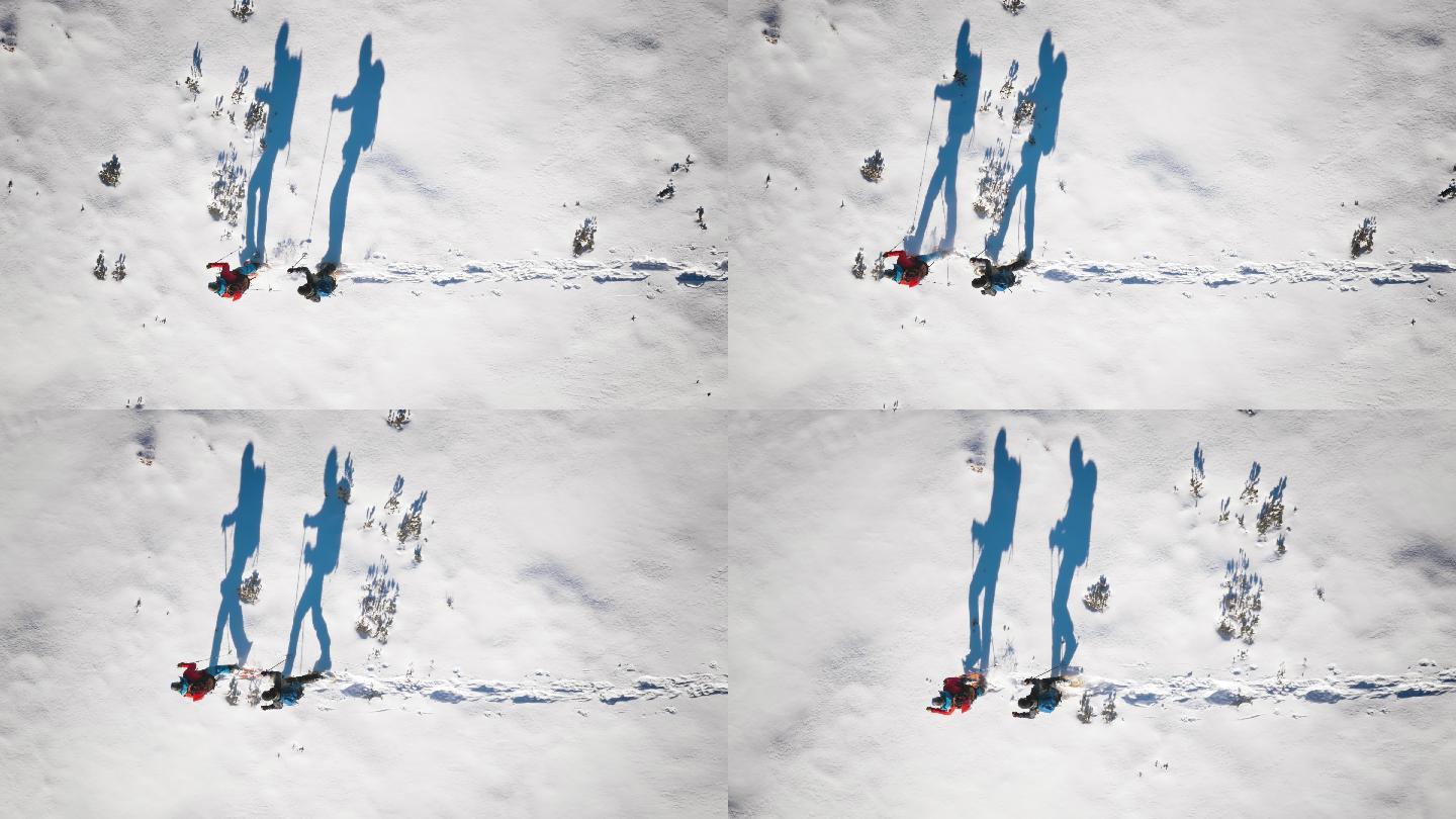 阳光明媚的雪鞋上登山者的航拍和他们的剪影