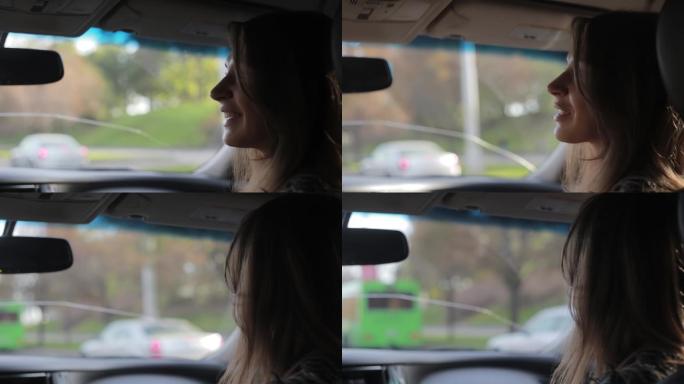 一个年轻女子在城市里开车兜风。