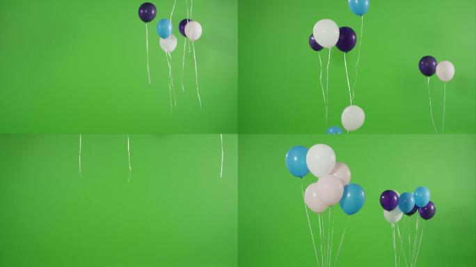 许多氦气球在绿屏上升起