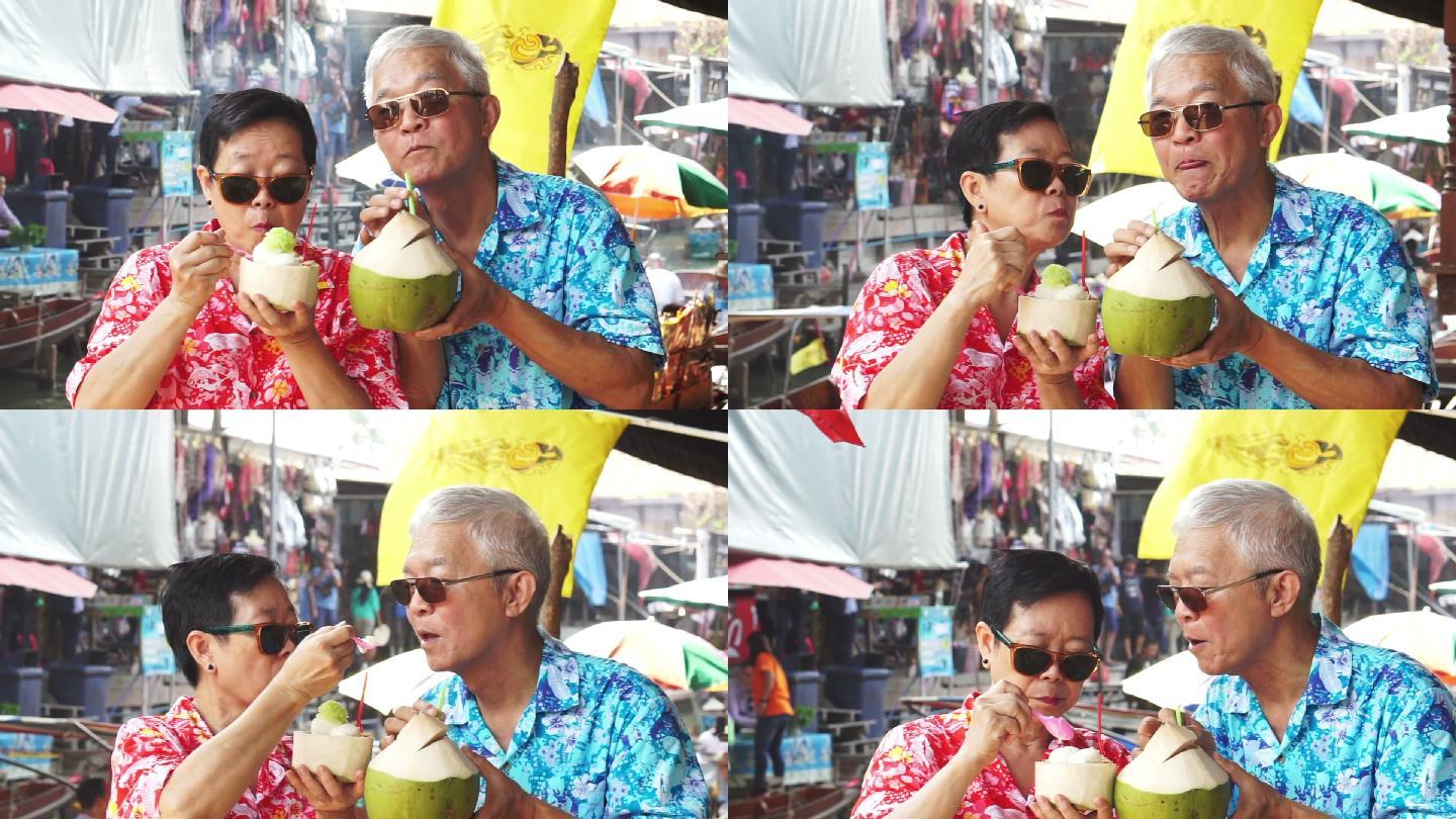 老年夫妇喝新鲜椰子汁