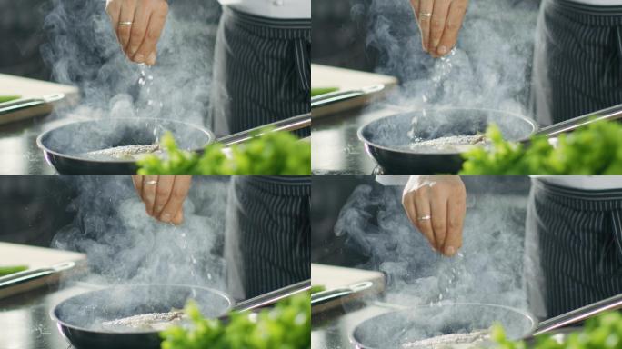 厨师在锅上煎鱼