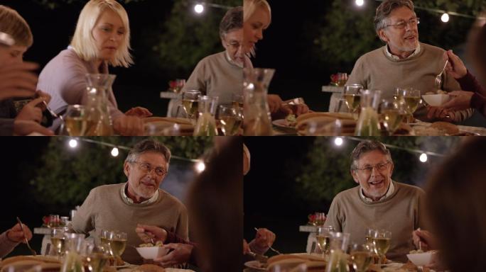 晚上全家在野餐桌边聊天吃饭