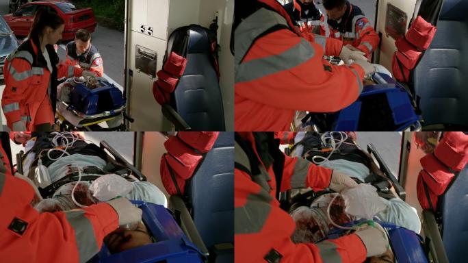 医护人员把一个在车祸中受伤的人抬上救护车