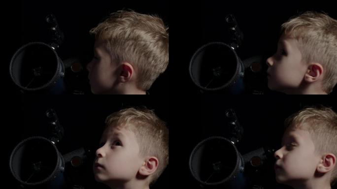 用望远镜观察夜空的男孩