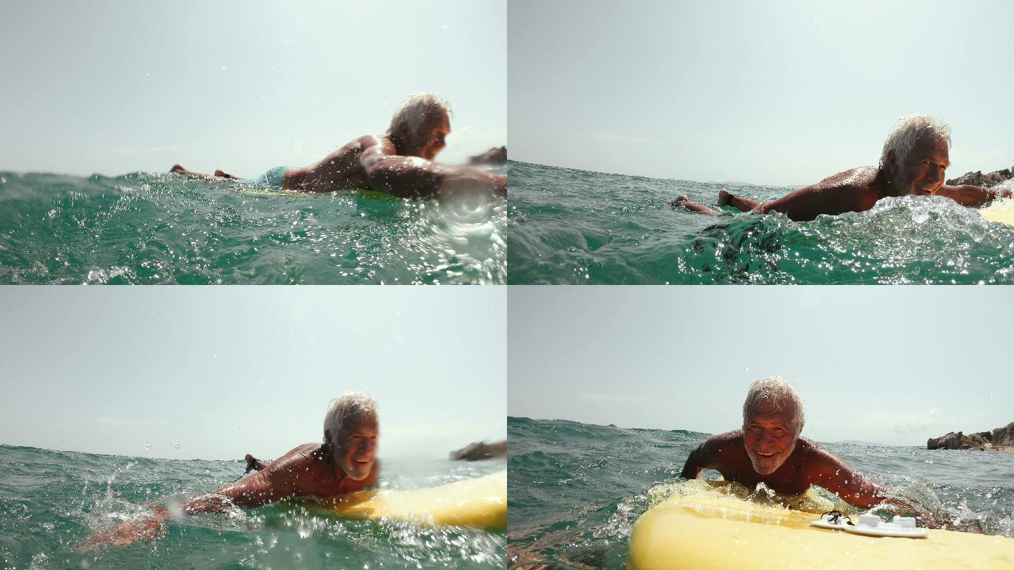 一个老人在海里冲浪