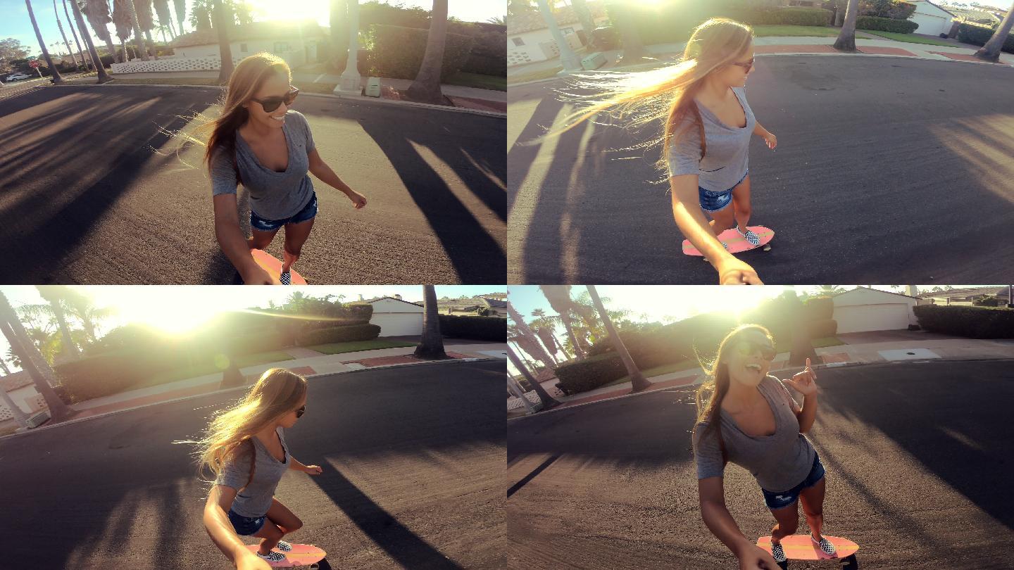 女孩手持自拍相机在街上玩滑板